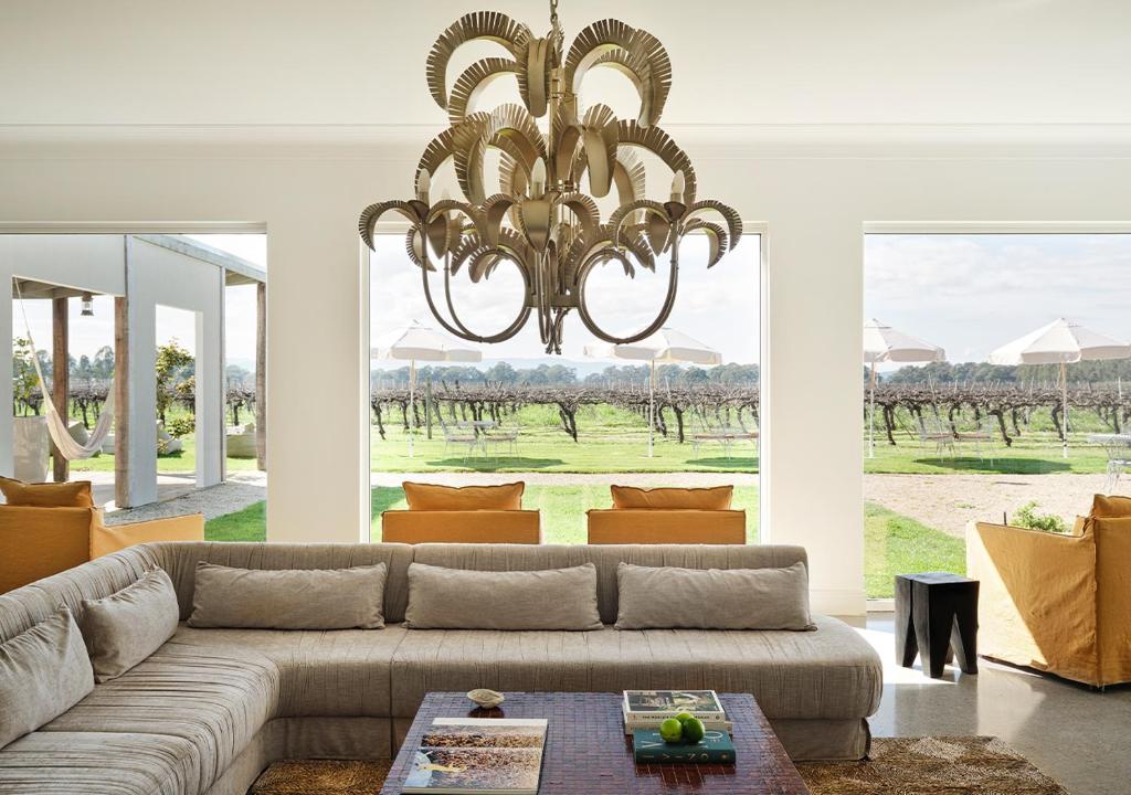 a living room with a couch and a chandelier at Lancemore Milawa in Milawa