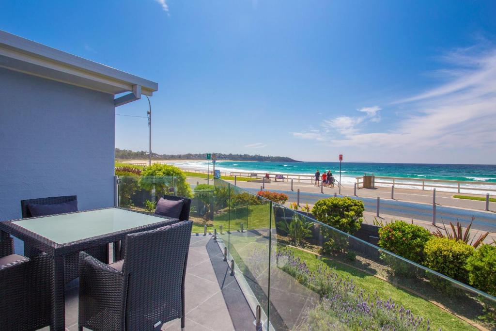 a balcony with a table and a view of the beach at Mariners 2 in Mollymook