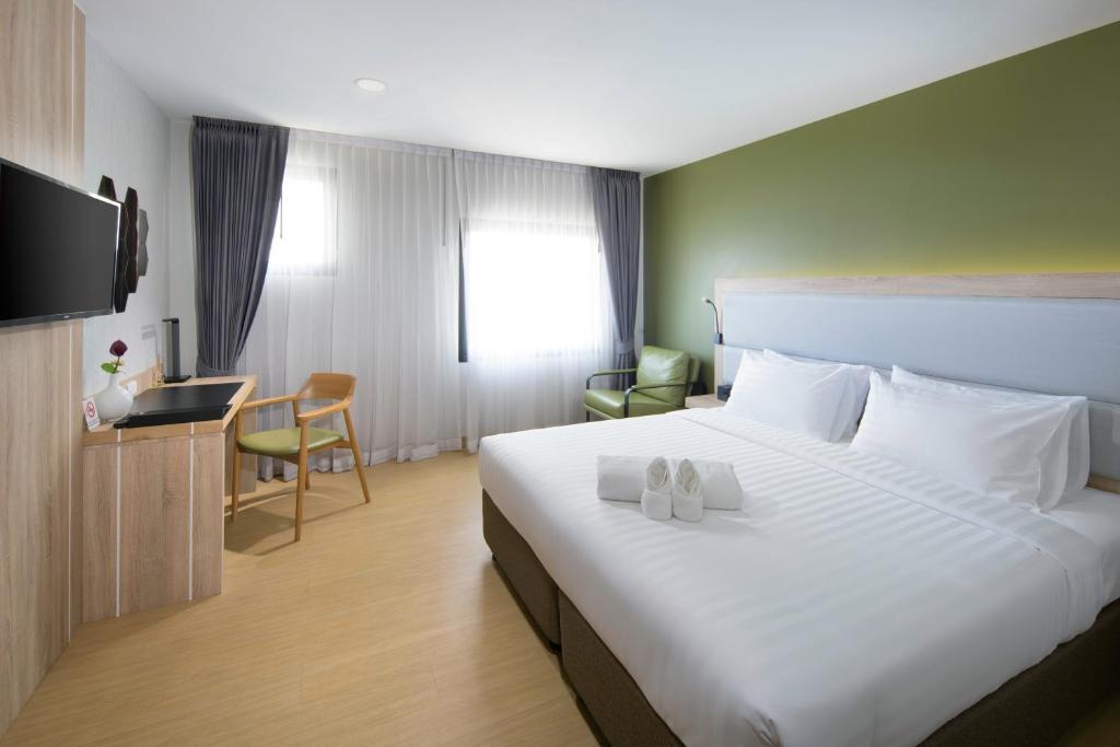 Postel nebo postele na pokoji v ubytování Prime Square Hotel