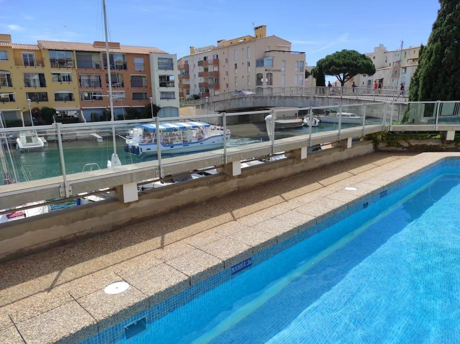 a bridge over a body of water with buildings at CONFORTABLE APPARTEMENT GRANDE TERRASSE PISCINE PARKING CLIM in Cap d'Agde