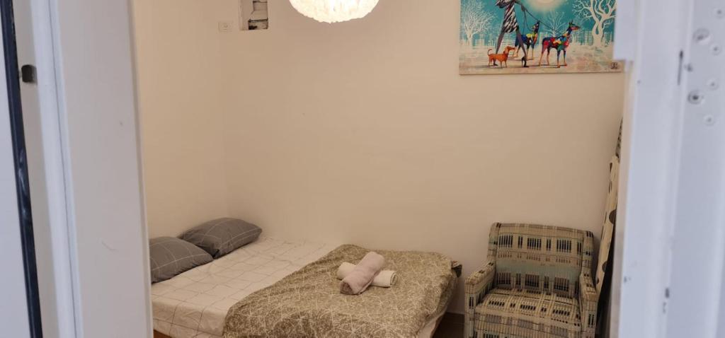 a small bedroom with a bed with a stuffed animal on it at Nahal Beer sheva נחל באר שבע in Beer Sheva