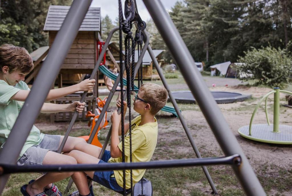 a group of children playing on a playground at Camping Siesta in Lille