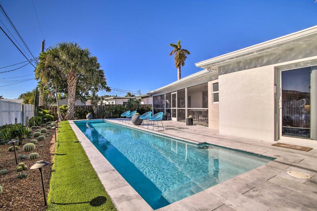 a swimming pool in the backyard of a house at 1 Mi to Deerfield Beach Stylish Studio with Pool! in Deerfield Beach