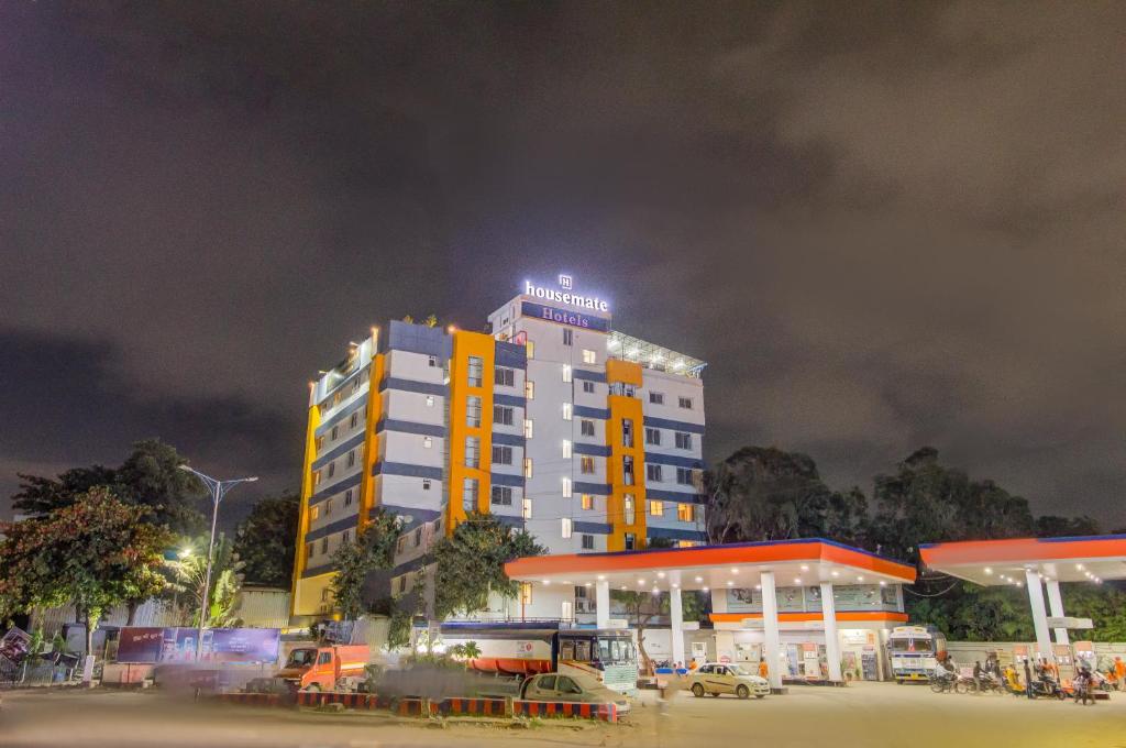 a building with a light on top of it at night at Housemate Hotel in Pune