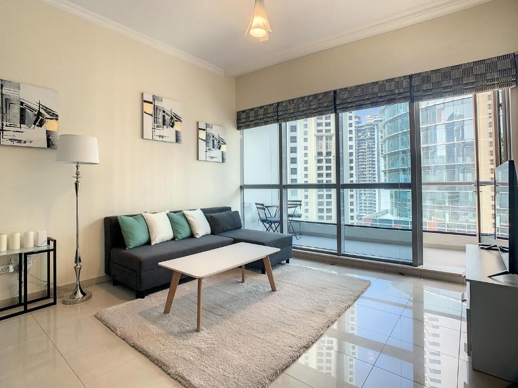 a living room with a couch and a table at Key View - Bay Central West in Dubai