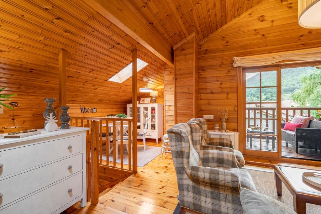 a log cabin living room with wooden walls and wooden floors at Espectacular apartamento de madera frente al río Ter - Camprodon in Camprodon
