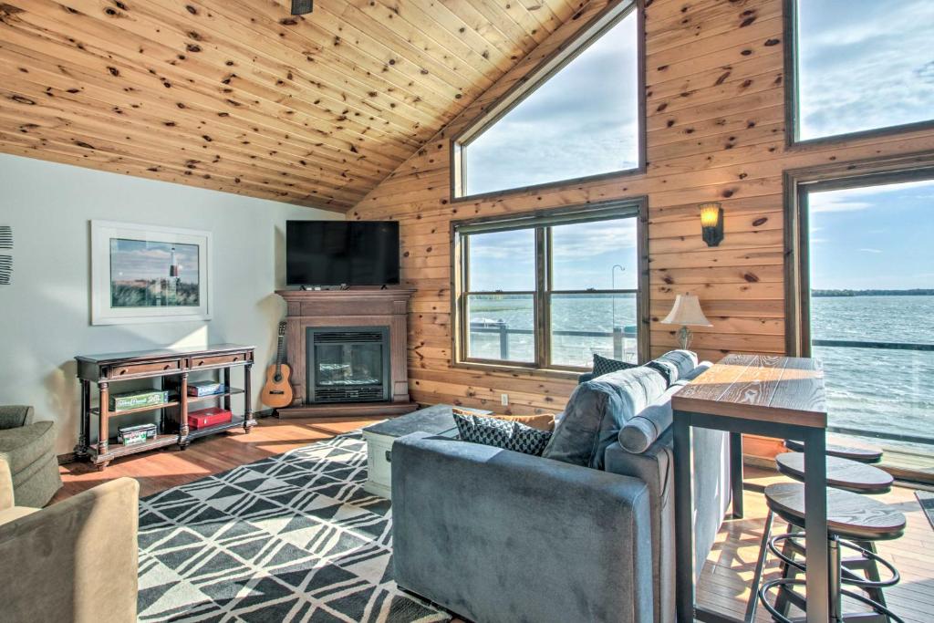 a living room with a couch and a fireplace at Delightful Isle Retreat with Boat Dock and Slip! in Isle