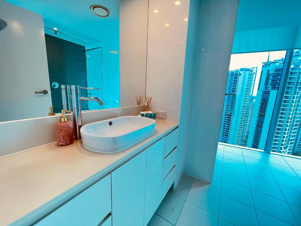 a bathroom with a sink and a large window at LUXURY APARTMENT- with WATER VIEWS FROM EVERY DIRECTION in Gold Coast