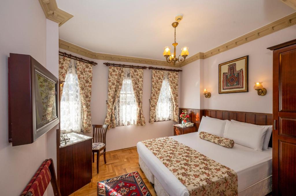 Postel nebo postele na pokoji v ubytování Osmanhan Hotel
