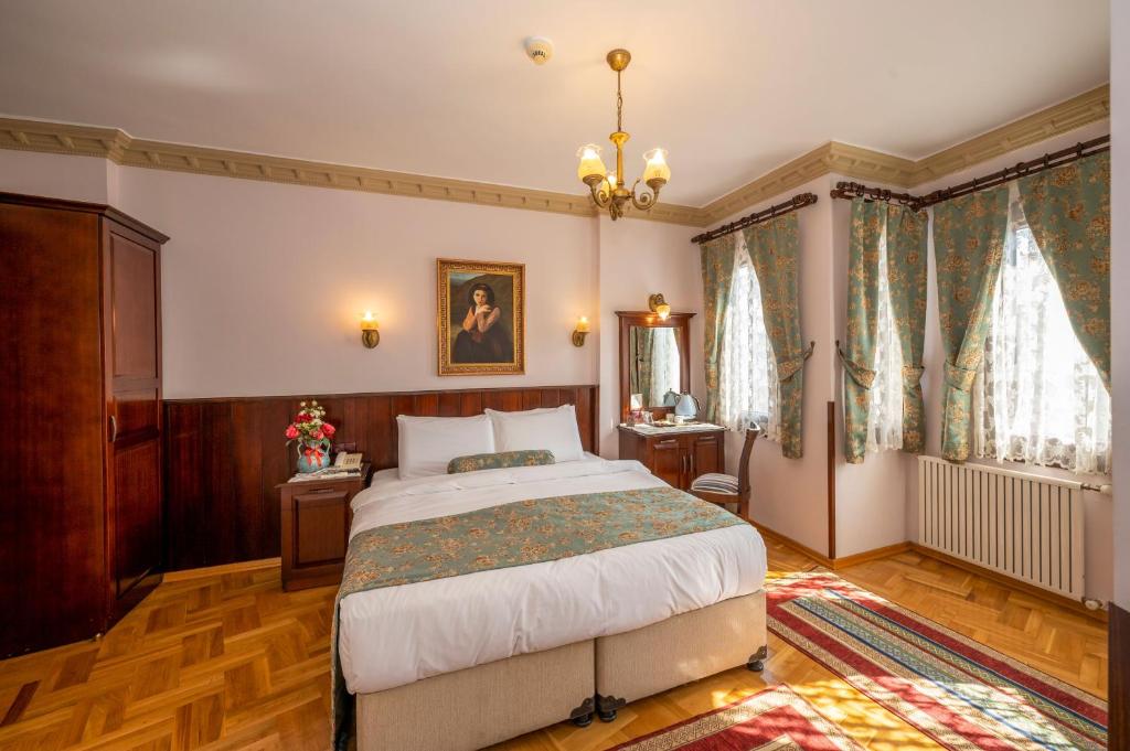 Postel nebo postele na pokoji v ubytování Osmanhan Hotel