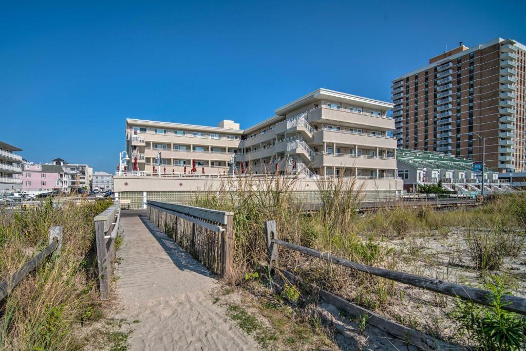 a building on the beach next to a building at Beachfront Studio Apartment with Community Pool in Ventnor City