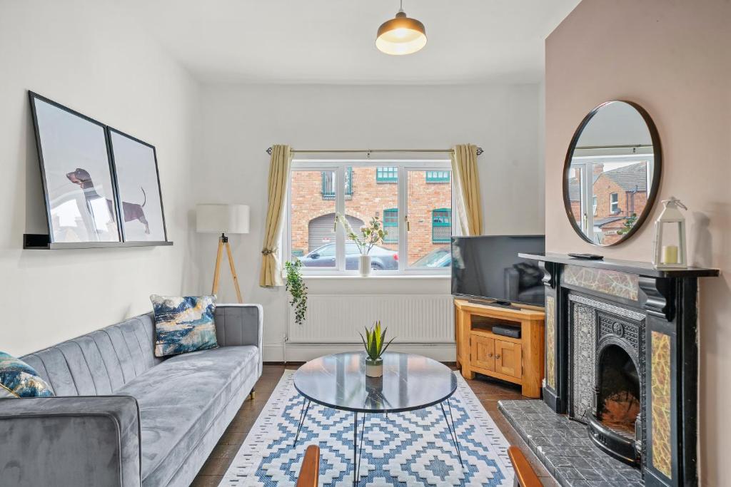 a living room with a couch and a fireplace at Central House with Parking, Pool Table, Super-Fast Wifi and Smart TV with Virgin TV and Netflix by Yoko Property in Northampton