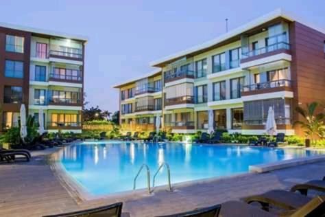 a large swimming pool in front of a building at Accra Pearl in City in Accra