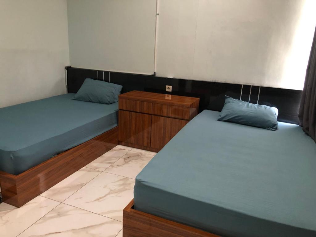 Postel nebo postele na pokoji v ubytování Bening Asri Guesthouse
