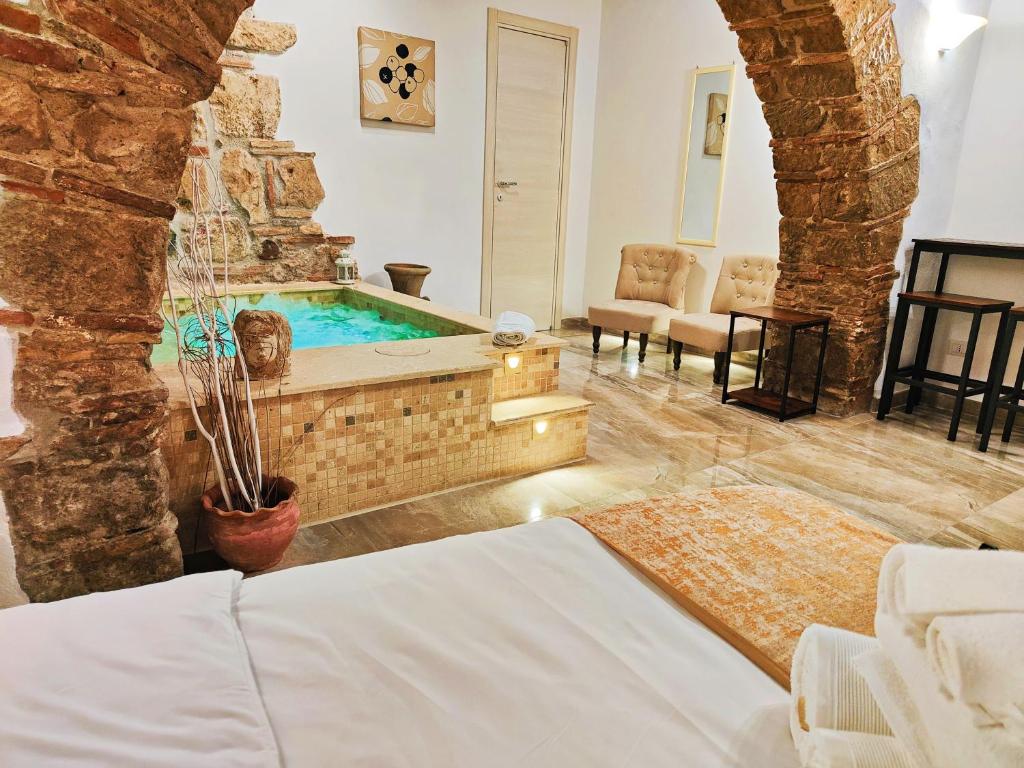 a hotel room with a swimming pool in a suite at Janara - Arco di Traiano in Benevento