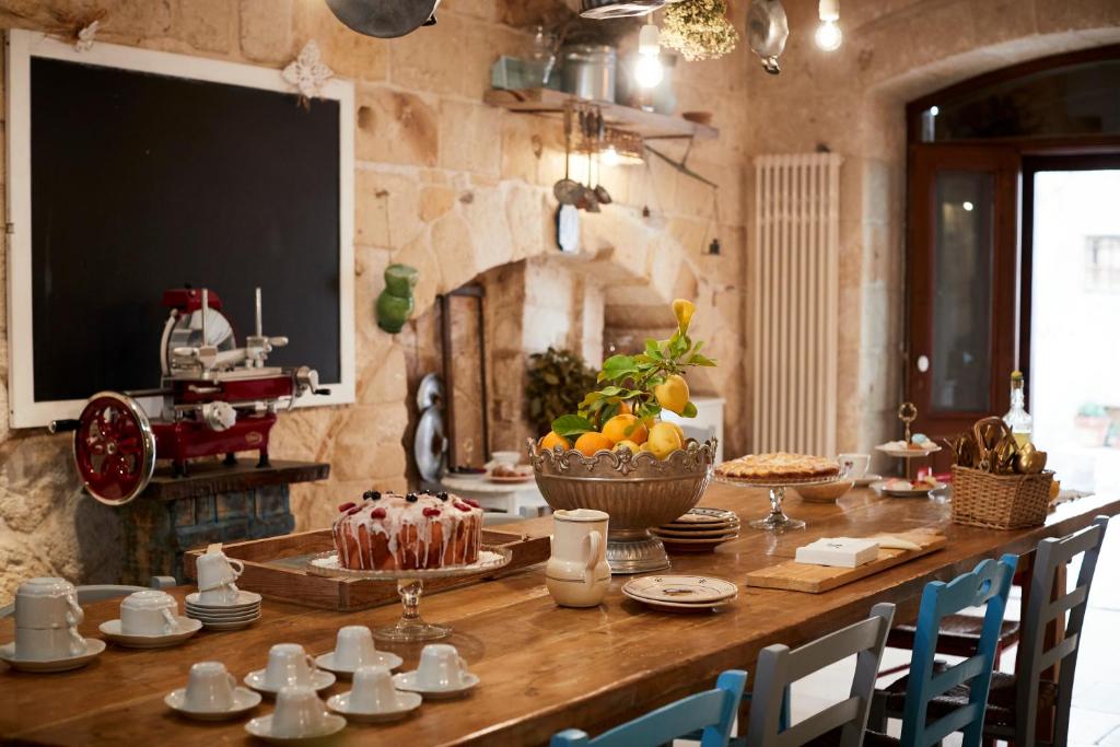 a kitchen with a table with a cake on it at Dei Serafini in Polignano a Mare