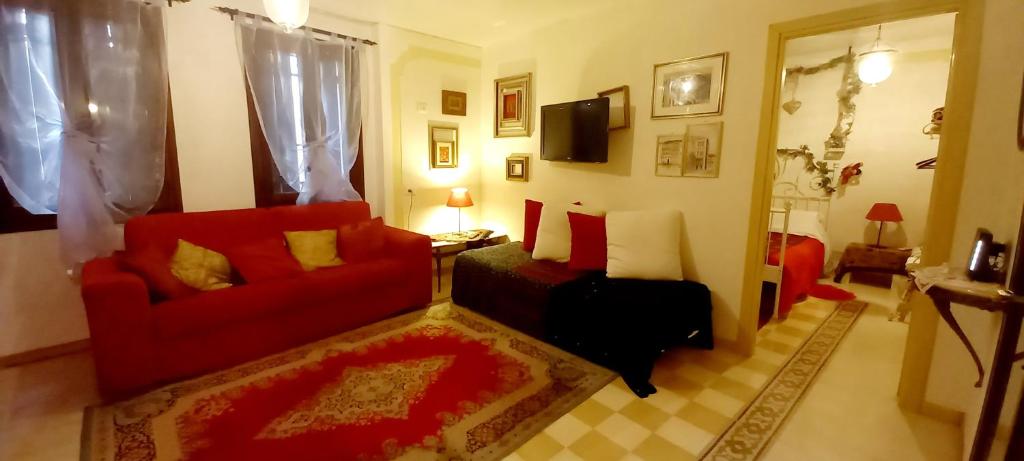 威尼斯的住宿－瓦倫蒂娜之家公寓，客厅配有红色家具和红色沙发
