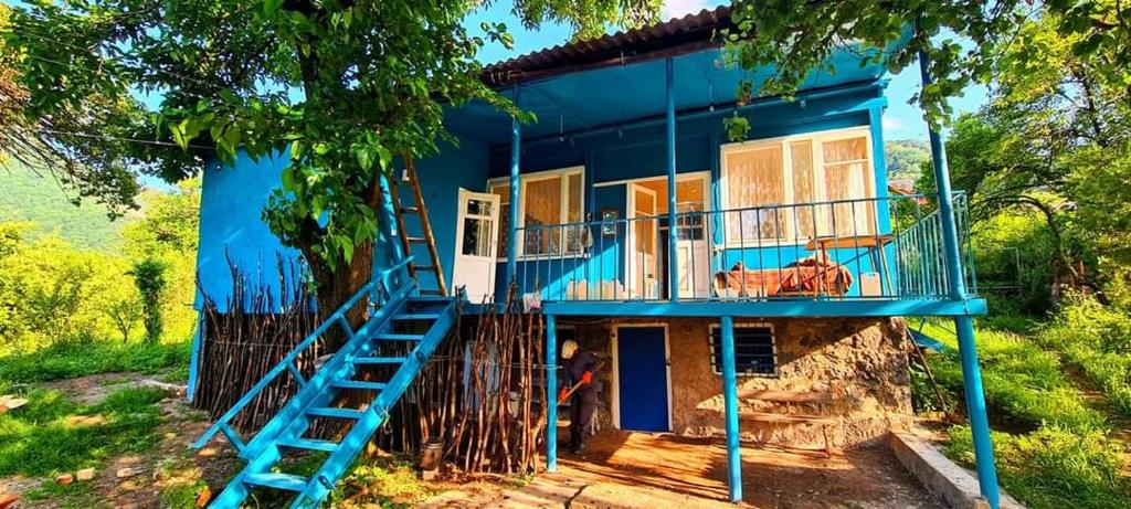 a blue house with stairs leading up to it at Papi Aygi in Alaverdi