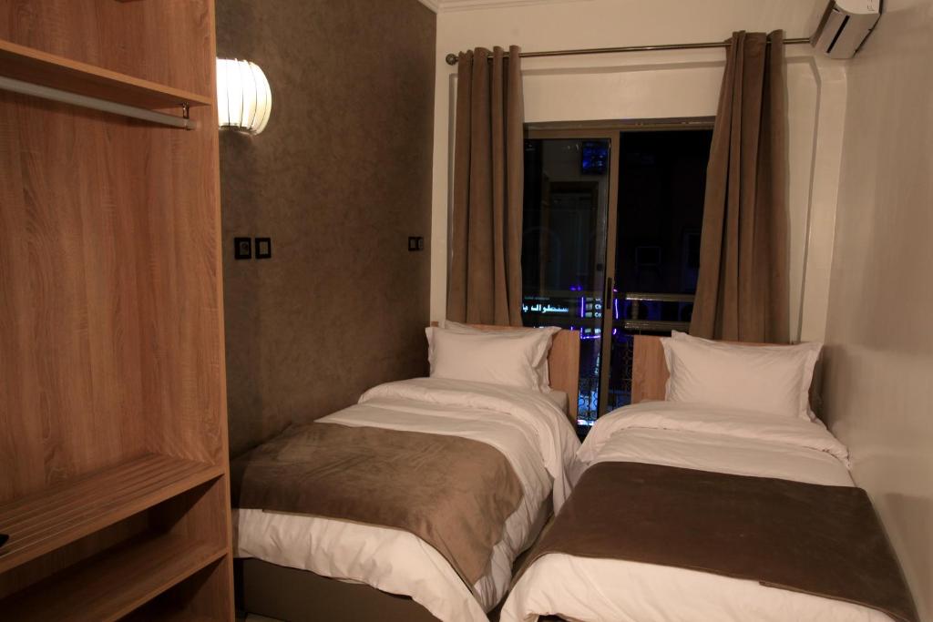 Postel nebo postele na pokoji v ubytování Hotel Ichbilia فندق اشبيلية