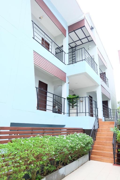 an apartment building with balconies and a staircase at 3B Apartment-SHA Extra Plus in Kamala Beach