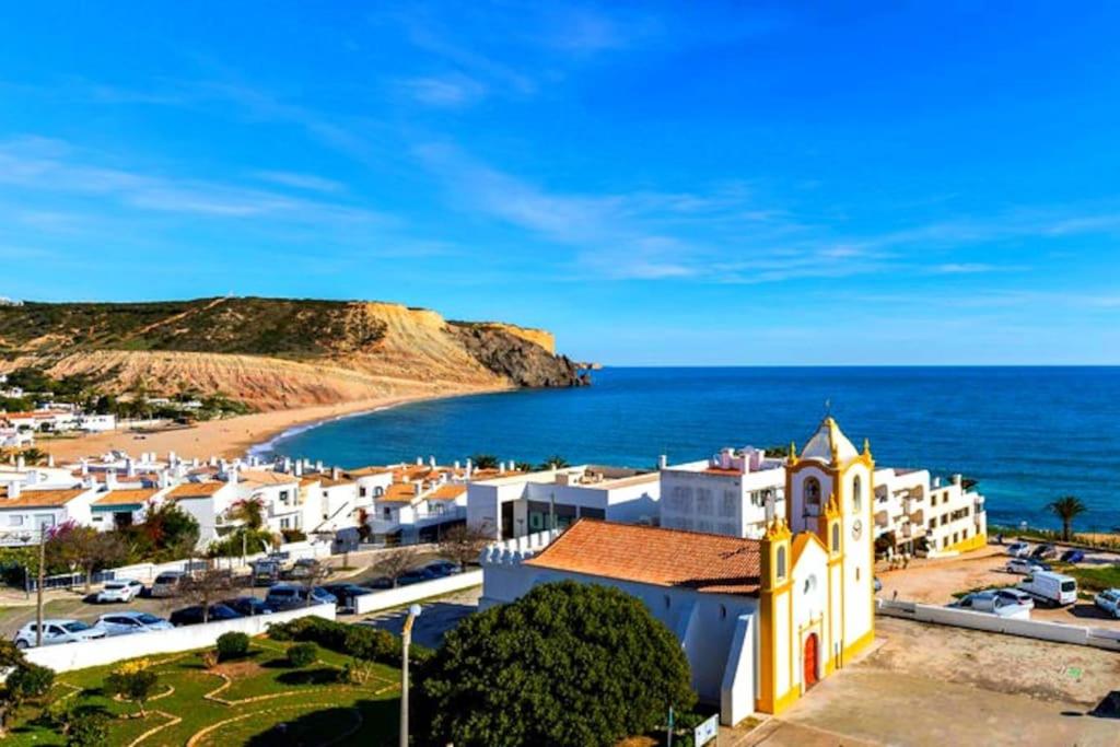 a view of a town and the ocean at PORTUGAL HOLIDAYS in Luz