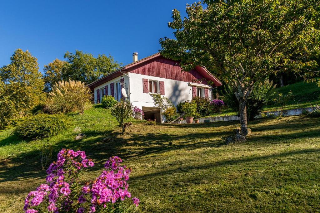 ein Haus auf einem Hügel mit Blumen davor in der Unterkunft Maison dans un parc de verdure in Verthemex