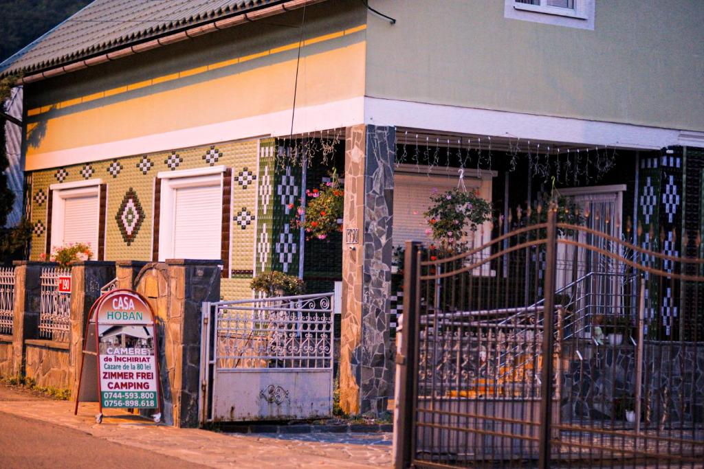 a house with a gate in front of it at CASA HOBAN in Baia Mare