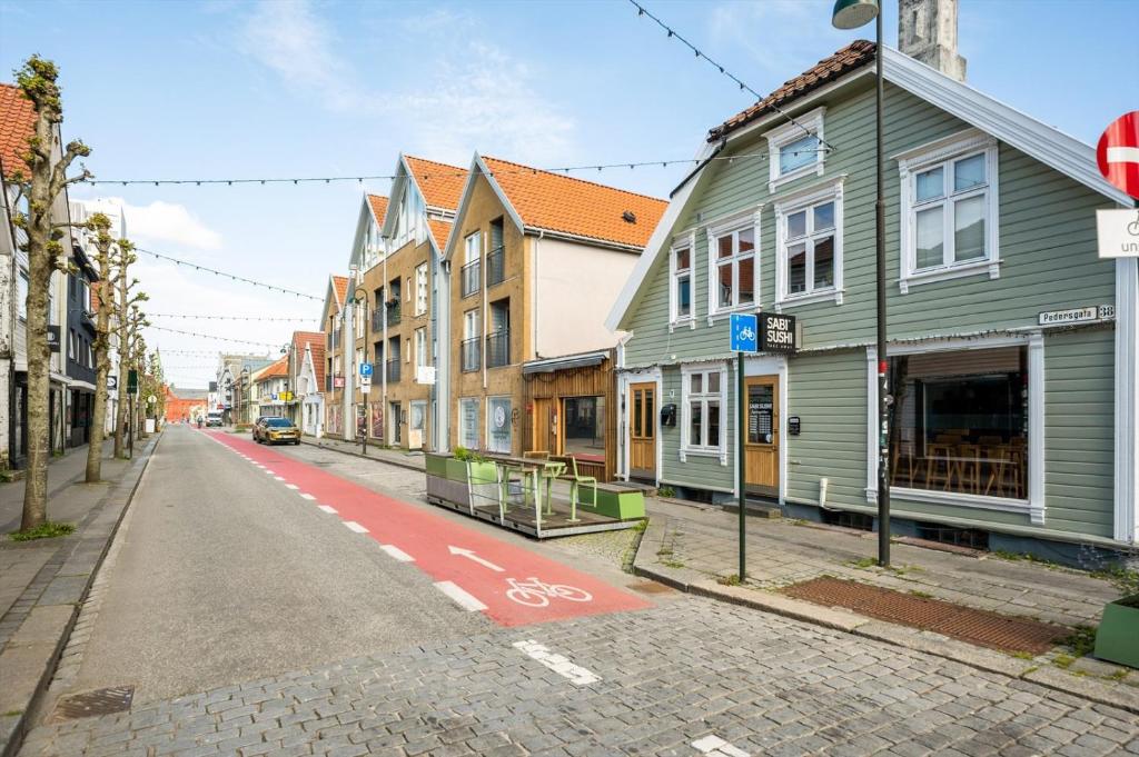 an empty street in a city with buildings at Apartment with two bedrooms and parking in Stavanger