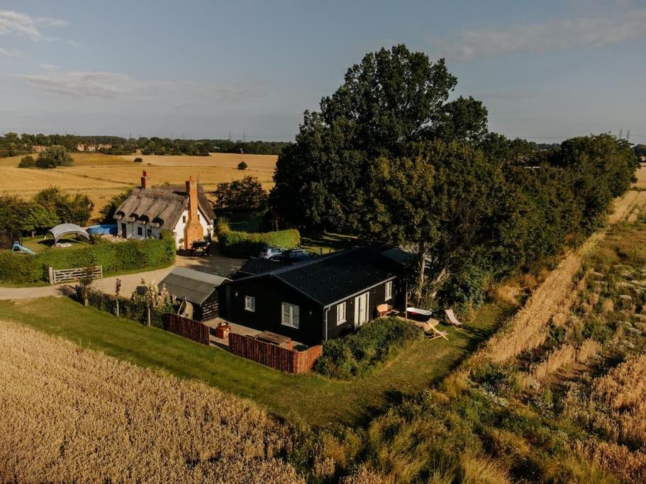 an aerial view of a house in the middle of a field at Beautiful Cottage in Bredfield near to Woodbridge on the Suffolk Coast in Bredfield