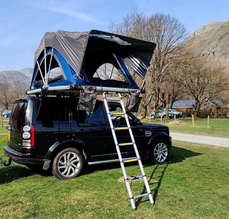 a camper on the roof of a van with a ladder at Scott Rooftop Tent Rental from ElectricExplorers in Hawkshead
