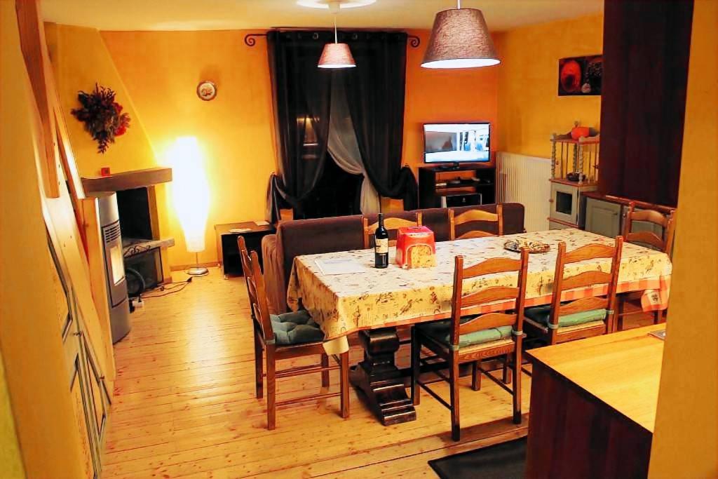 a dining room with a table and some chairs at Brici's House 69 in Passo del Tonale