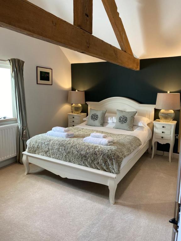 a bedroom with a large white bed in a room at The Brosterfield Suite - Brosterfield Farm in Bakewell