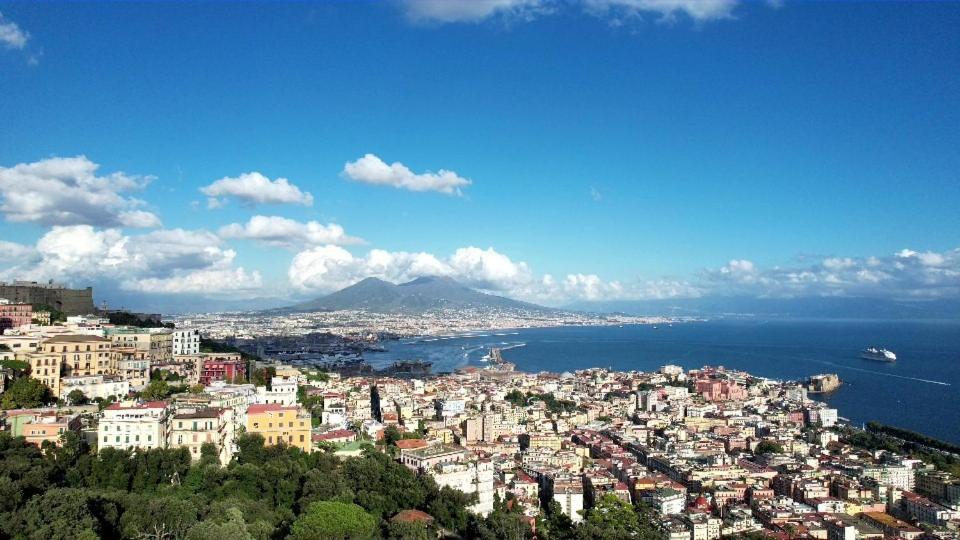 a view of a city with a mountain in the background at Residenza d’epoca Chiostro San Francesco in Naples