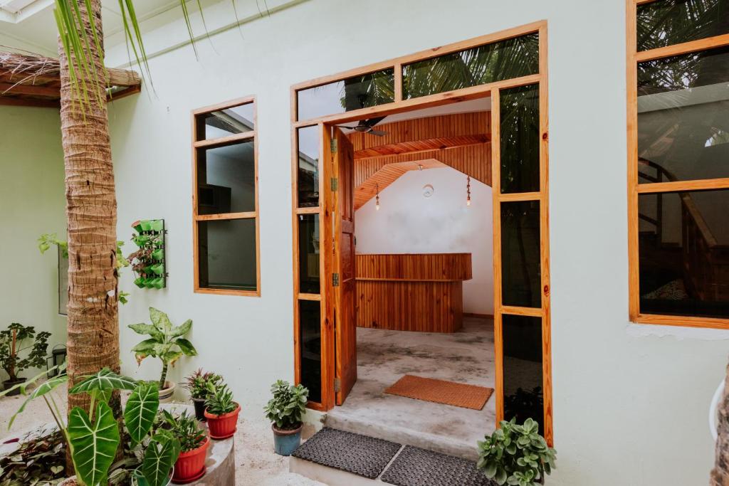 una porta aperta di una casa con piante di Isla Dhiffushi a Dhiffushi