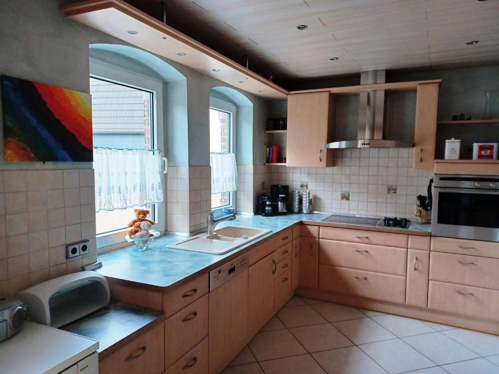 a kitchen with wooden cabinets and blue counter tops at JANs in Herdorf