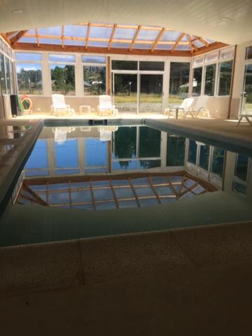 a swimming pool in a house with a view at Hosteria Andina in Esquel