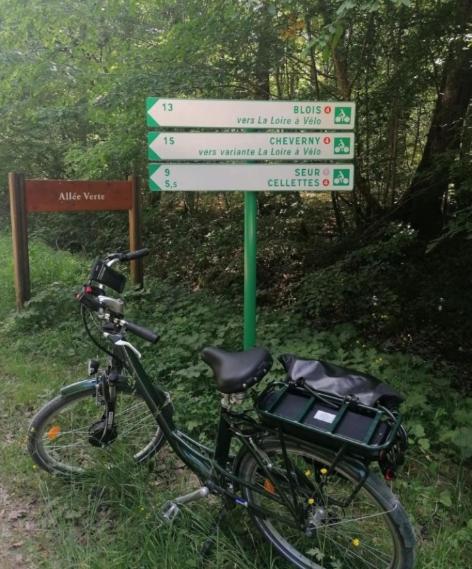 a bike parked next to a sign on a trail at Passage du Cygne in Blois