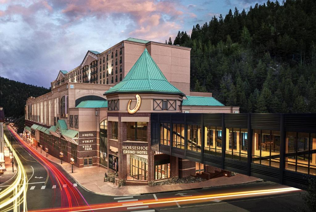 a large building with a green roof on a street at Horseshoe Black Hawk in Black Hawk