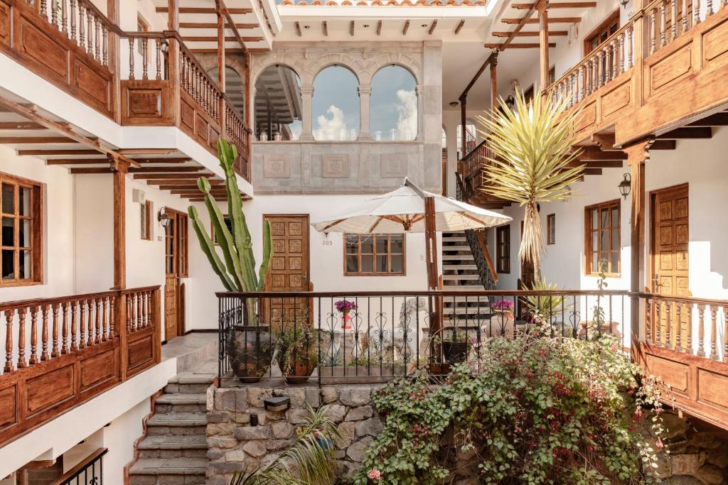 a courtyard of a house with stairs and plants at Andenes in Cusco