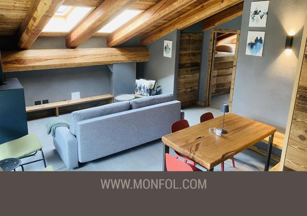 a living room with a couch and a table at Grand Maison Monfol in Oulx
