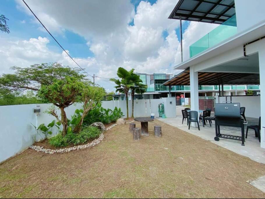 a patio of a building with a table and chairs at 55 Cozy Home Mount Austin Eco Adda Setia Indah Daya in Johor Bahru