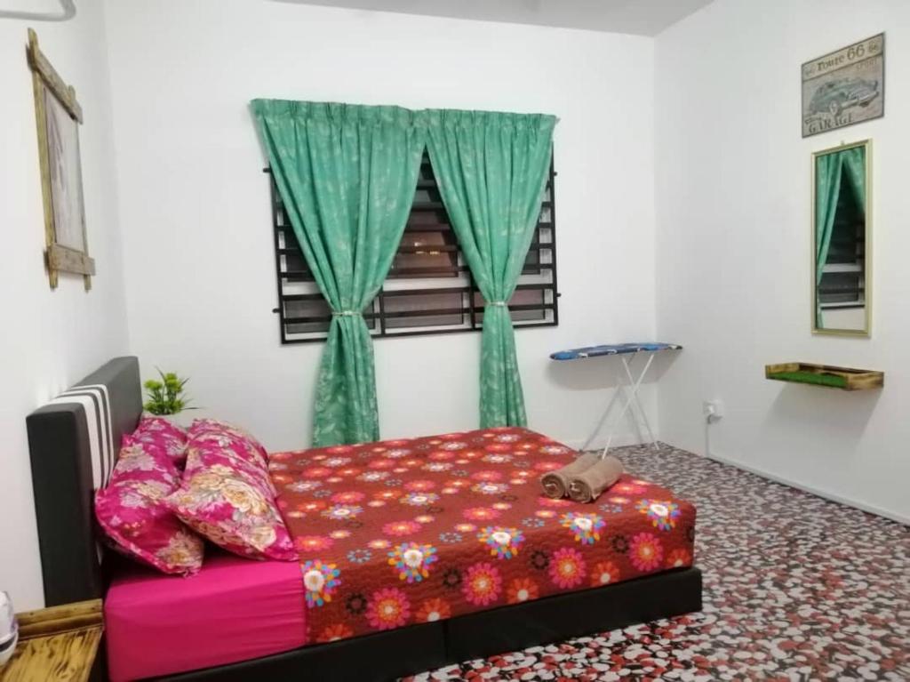 a bedroom with a red bed and a window at Seroja Residence Kuala Terengganu in Kuala Terengganu