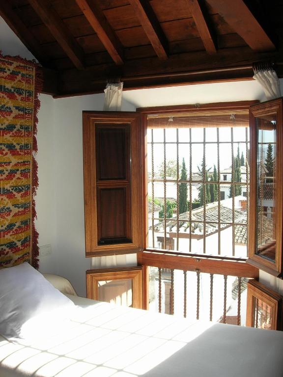 Postel nebo postele na pokoji v ubytování Hotel Santa Isabel La Real