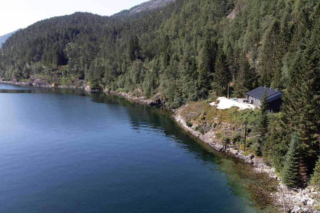 an aerial view of a lake with a house on the shore at Modalen Fjord Cottage in Mo