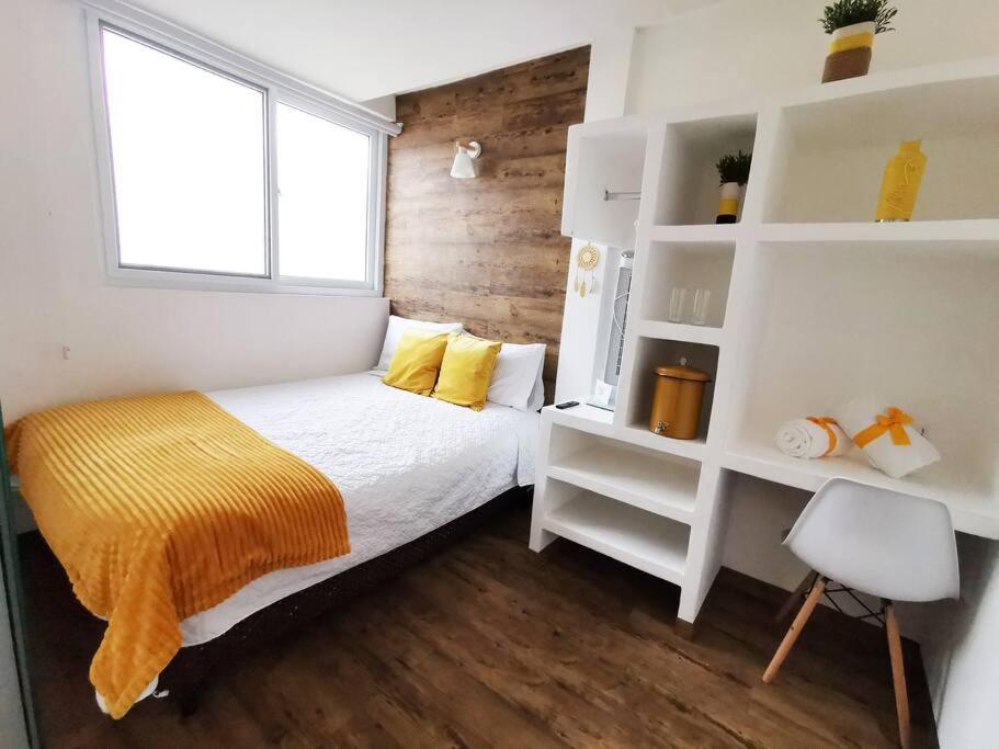 a small bedroom with a bed and a window at Preciosa Habitacion G in Guatemala