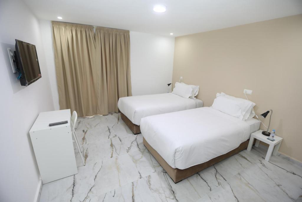 Una cama o camas en una habitación de MJI GROUP