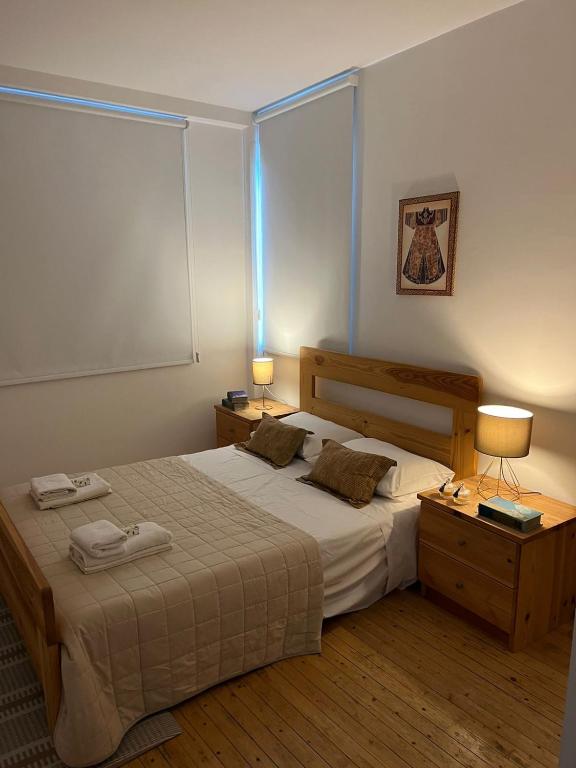 a bedroom with a large bed with two lamps on it at Demetra 1 Bdr Down Town Nicosia in Nicosia
