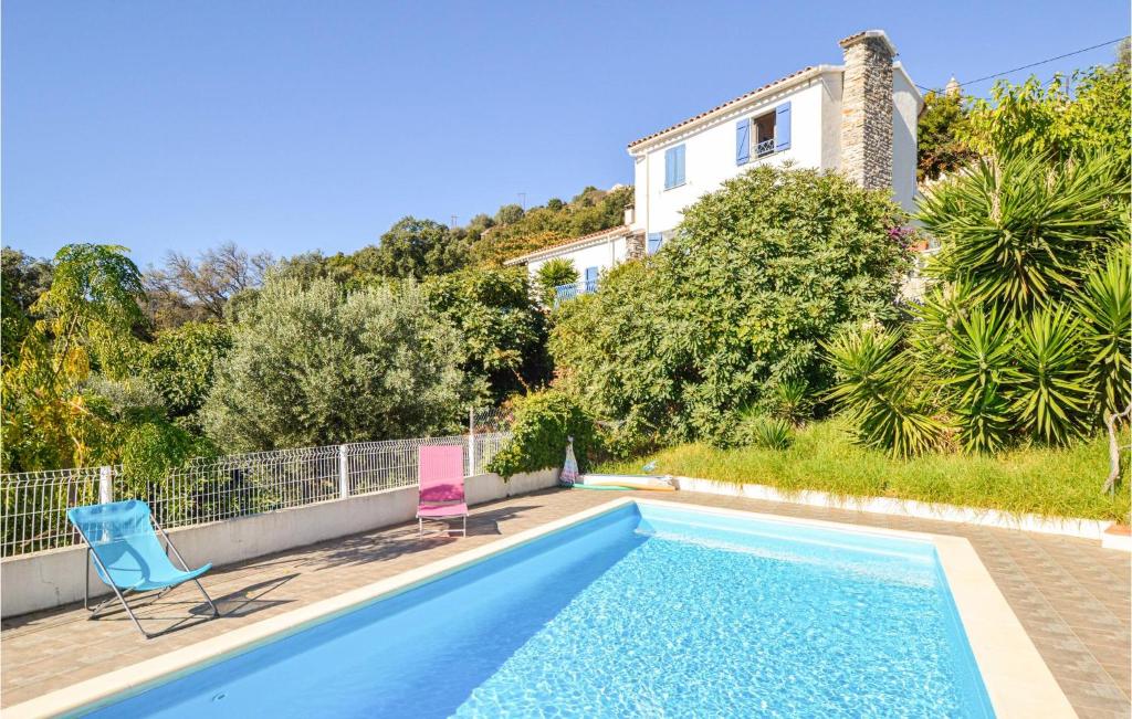 a swimming pool with two chairs and a house at Nice Home In St Andrea Di Cotone With Outdoor Swimming Pool, Wifi And Private Swimming Pool in Careggia