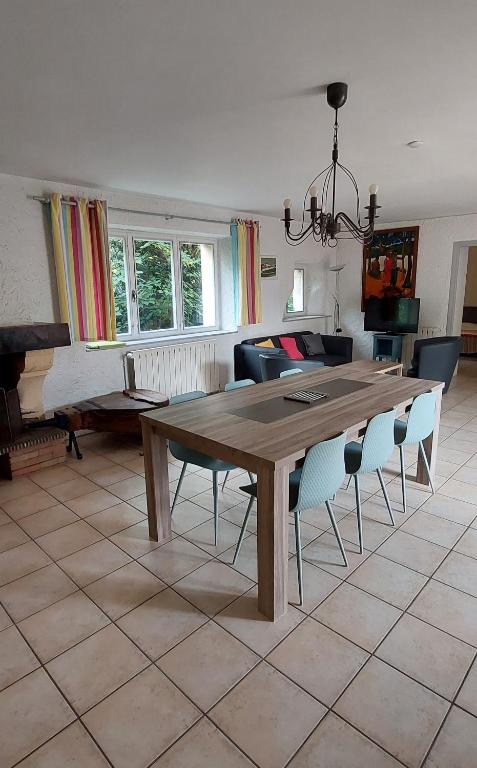 a living room with a wooden table and chairs at La Ginelle - Appartement Isba in Airoux