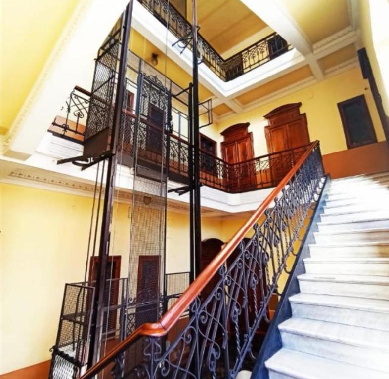 a staircase in a building with wrought iron railings at MansardaTO - La Tua casa nel cuore di Torino in Turin